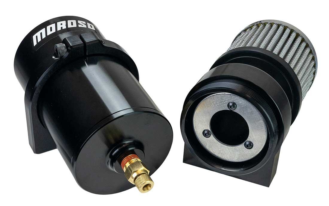 A Moroso billet catch can opened in two halves, showing the brass petcock drain on the billet bottom and the top section with the breather and internal baffle plate
