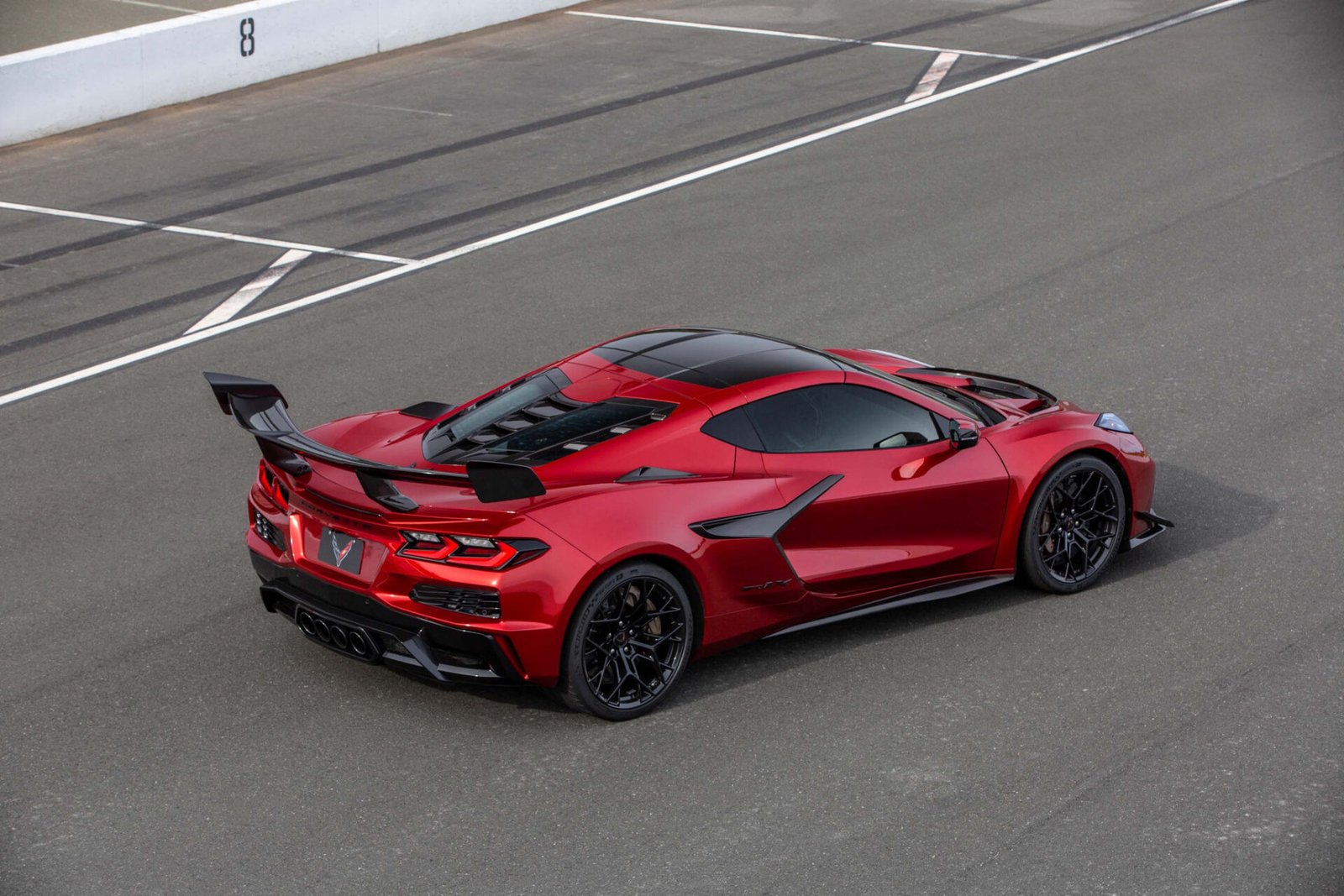 Red 2026 Chevrolet Corvette ZR1X coupe with its high wing, seen from above and behind at Sonoma Raceway